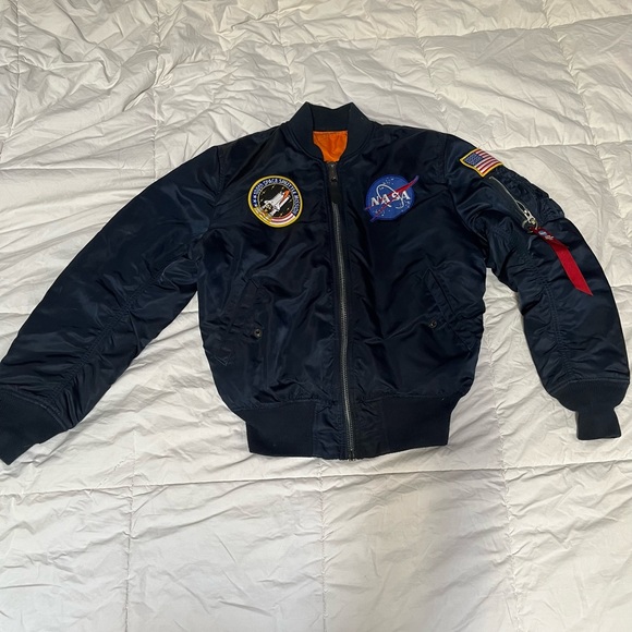 Navy blue bomber jacket With orange inside 
Goes for $300
Flips inside out - Picture 1 of 7